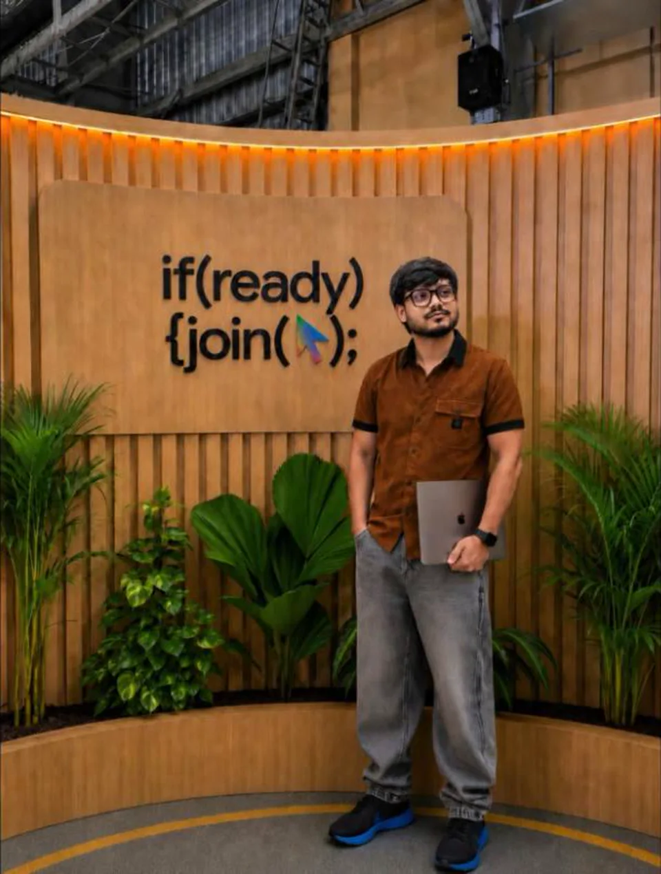Siddhant Gour holding a laptop in front of an if(ready) join() sign