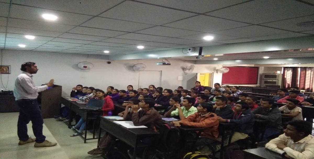 A classroom of students listening to a cyber security lecture