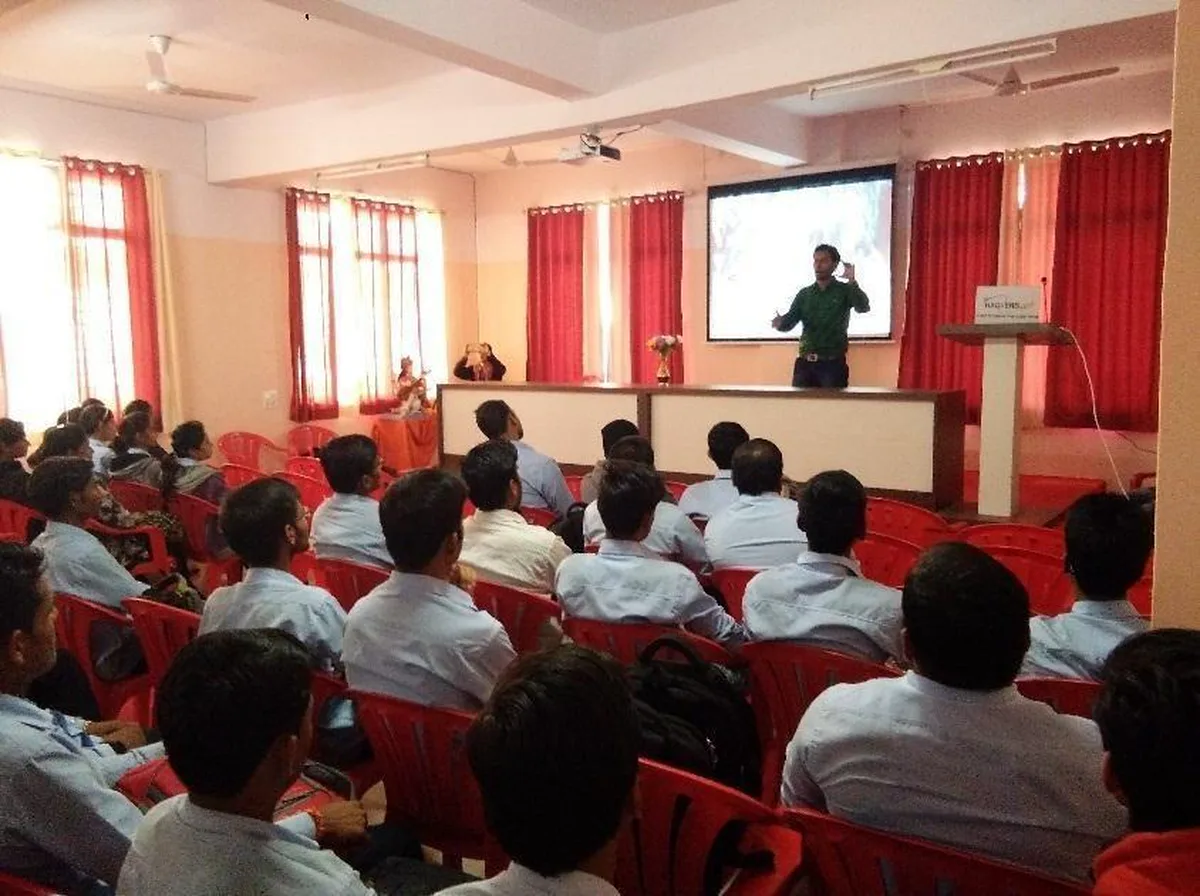 A full seminar hall watching a cyber security talk on a projector screen